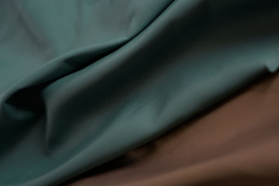 Petrol and brown lambskins, draped